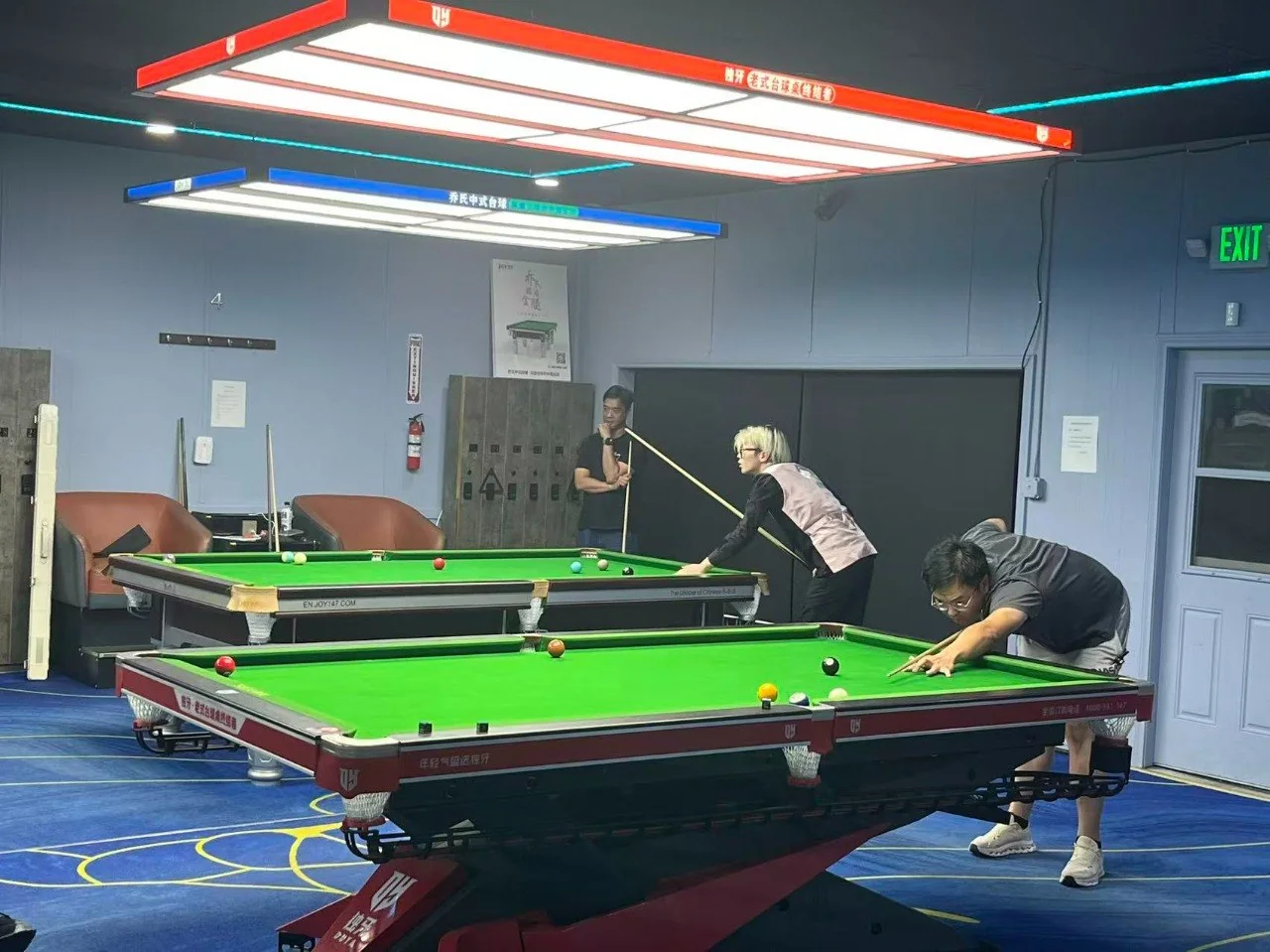 Players practicing on Cue Action Chinese 8-Ball tables